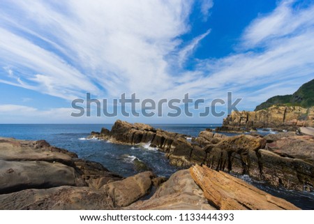 Beautiful scenery of a rocky beach in northern Taiwan on a sunny morning, with unique rock formations on the coast.(Long exposure)