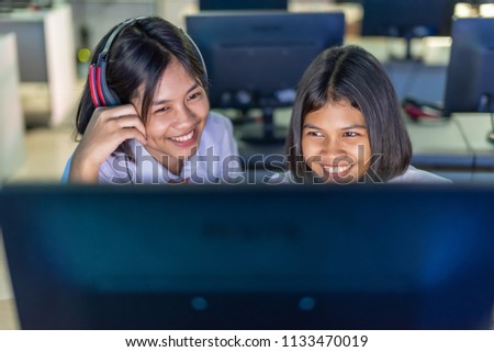 Female high school students are enjoying social media in computer room, Thailand , southeast Asia.(Original style image)