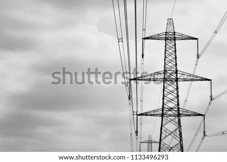 Electricity pylon against storm clouds