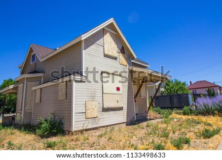 Boarded Up Home Lost In Foreclosure Royalty-Free Stock Photo #1133498633