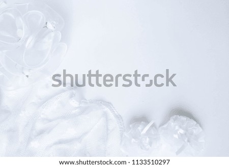 wedding white background with silk bows with ribbons and laces with blue tint
