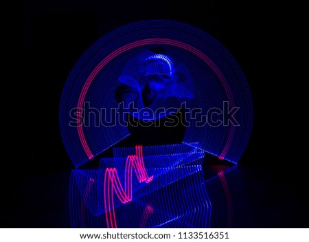 Electric Blue Light Painting Photography, Parallel Lines, Waves And Curves Against A Black Background