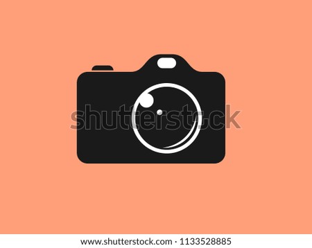 
PHOTOGRAPHIC CAMERA IN THE PICTURE CENTER ON AN ORANGE BACKGROUND.ICON
