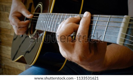   hands playing classic guitar                             
