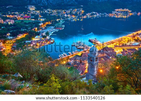 Fantastic aerial panoramic summer view from the mountain to the bay of Kotor, Mediterranean Balkans, Montenegro, Europe. Traveling concept background. Incredible street lights in the sunset. Postcard
