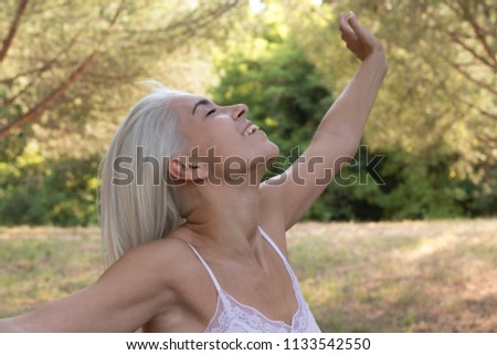 Relaxing woman breathing fresh air in the countryside