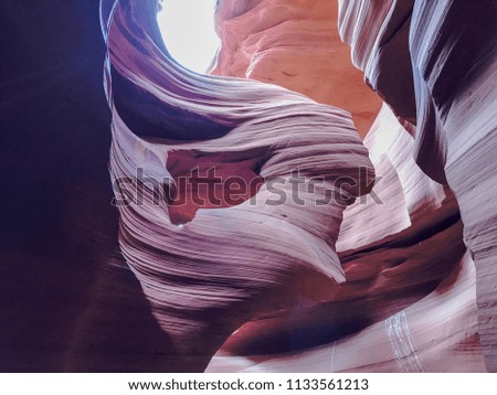 Lower Antelope Canyon. A slot canyon in the American Southwest. It is on Navajo land east of Page, Arizona. A narrow canyon, formed by the wear of water rushing through rock. 