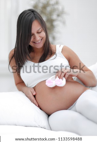 beautiful pregnant woman sitting in the living room.