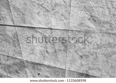 Background of textured paper in gray with folds