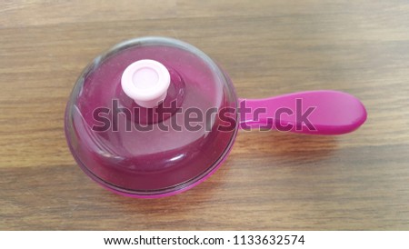 Frying pan for kids in wood background