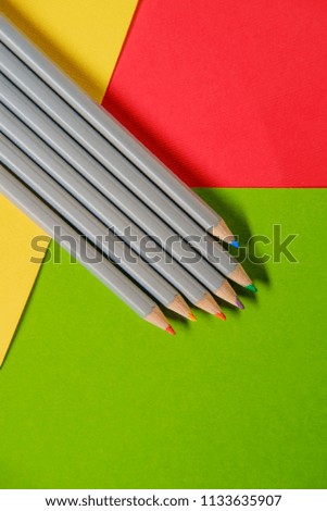 Vibrant artist colored pencils still life with paper background