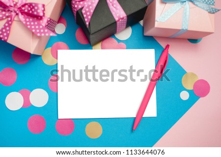 Decorated boxes and blank white sheet of paper as a concept of holiday gifts and congratulations.