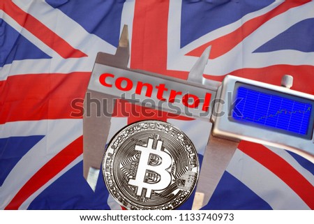 Finance concept, Bitcoin on the background a Flag of England, bitcoin control, bitcoin in a caliper, a board with a trend of crypto currency