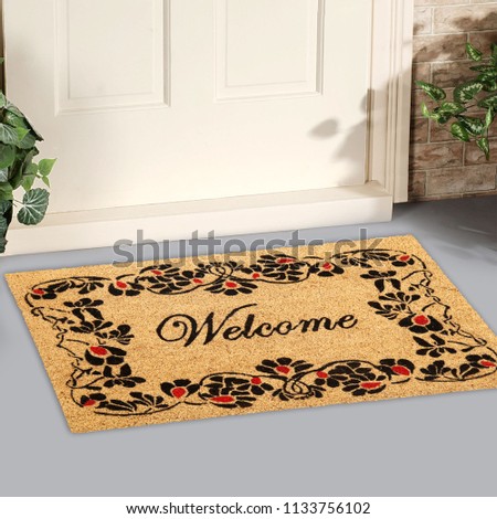 Beautiful welcome peach color coir doormat with flower border Placed outside door