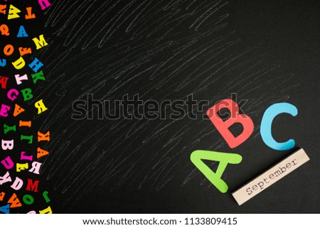 Back to school background. Top view of school supplies on chalkboard