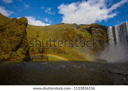 Skogafoss waterfall and raibow in sunny day in Iceland