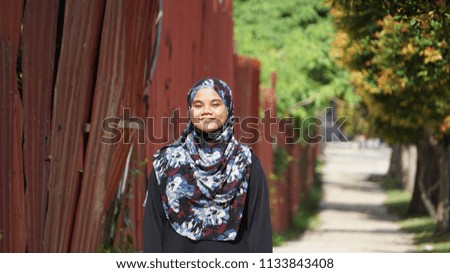 A cute hijab girl smiling on the road.