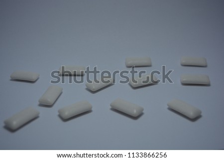 White cushions from chewing gum on the white paper