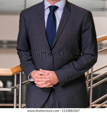 Close-up cropped Caucasian hands and arms of businessman in an office