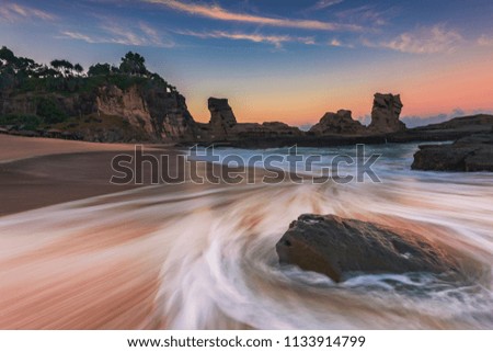 Long exposure of Klayar beach, Pacitan, East Java, Indonesia. Its the most beautiful beach in Java Island. High resolution view of motion blur wave around the rocks