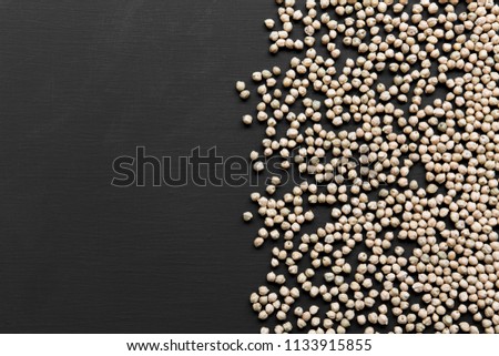 Dried chickpeas on a black background, top view. Copy space and text area.