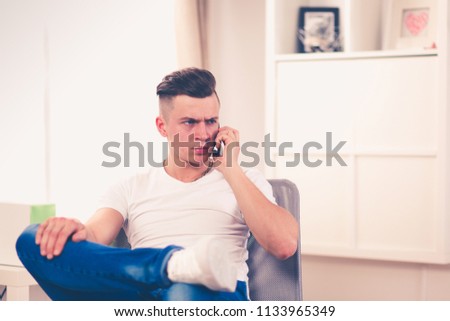 Young man resting in armchair. Joy of life