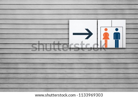 Unisex restroom or toilet and arrow sign 