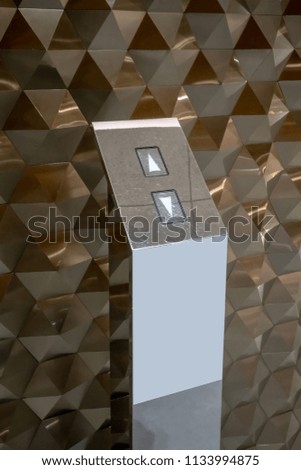 Luxury elevator buttons on chrome stand againts hexagon texture pattern background