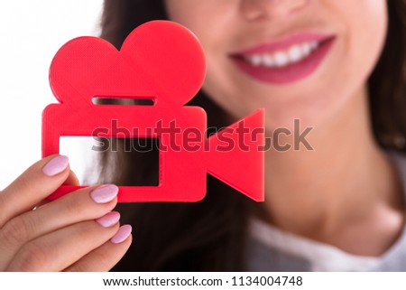 Photo Of Businesswoman's Hand Holding Red Movie Camera