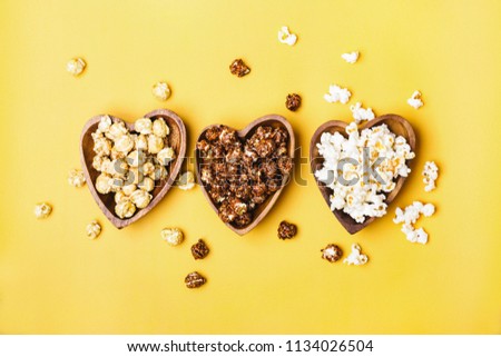 Set of sweet and salted popcorn in wooden bowls.