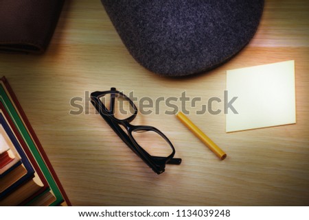 books hat pencil paper glasses 