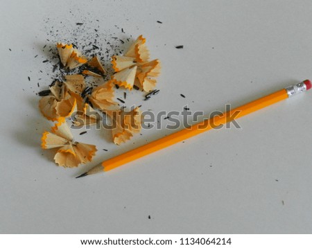 Sharpened pencil and shavings on white background