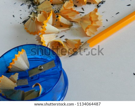 Sharpened pencil and shavings on white background