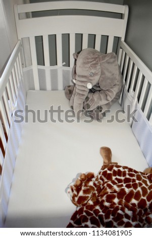 Baby crib freshly painted for newborn baby with elephant and giraffe friends