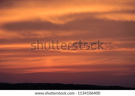 Countryside Landscape Under Scenic Colorful Sky At Sunset Dawn Sunrise. Sun Over Skyline, Horizon. Bright Dramatic Sky And Dark Ground. Warm Colours. Natural Sunset Sunrise Over Field Or Meadow. 