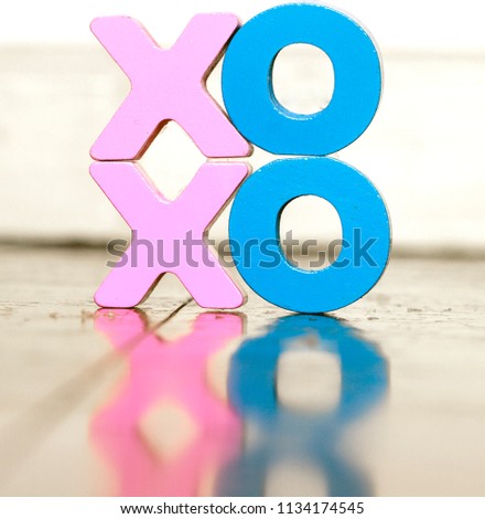 XO XO wooden letters on a old wooden floor with reflection  soft color