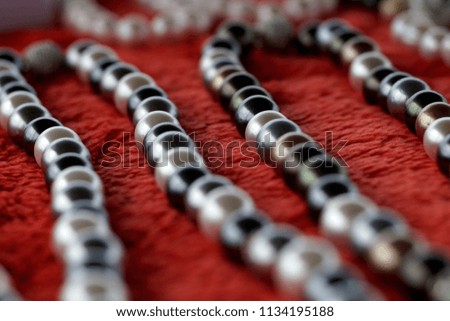 Mixed color pearl necklace on a red velvet