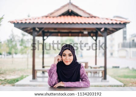 Girl in hijab over building background