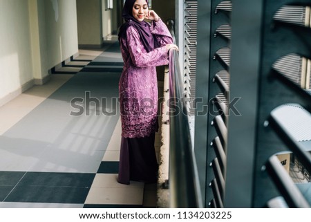 Girl in hijab over building background