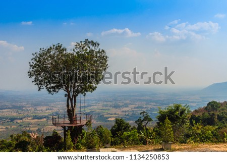 Tree of love in heart shaped with the green valley, blue sky and mountain range background. This public area is located at Ban Ruk Thai village, Noen Maprang district, Phitsanulok province, Thailand. Royalty-Free Stock Photo #1134250853