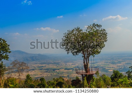 Tree of love in heart shaped with the green valley, blue sky and mountain range background. This public area is located at Ban Ruk Thai village, Noen Maprang district, Phitsanulok province, Thailand. Royalty-Free Stock Photo #1134250880
