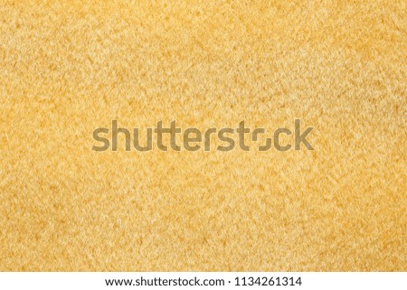 Light yellow material background. High resolution photo.