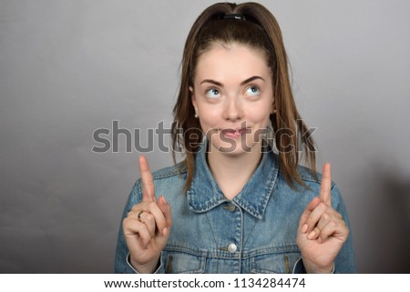 portrait of a pretty girl in a denim jacket, a finger