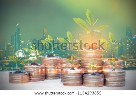 Double exposure of Trees growing on coins money on city background, Saving money for Real estate investments and business concept
