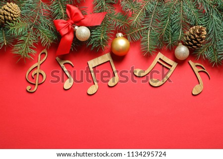 Flat lay composition with decorations and  notes on color background. Christmas music concept