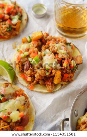 Mexican tacos with chili con carne, grilled sweet potatoes and grated cheese on white background. Text space