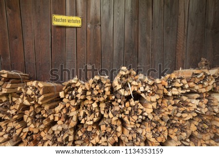 perfectly stacked pine firewood. No smoking label on the background