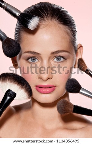 bright closeup portrait picture of beautiful woman with brushes