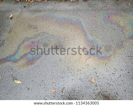 Oil leakage car showing in puddle of rain