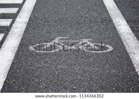 white reflective painted bicycle sign, bicycle lane on the road for pedestrian crossing